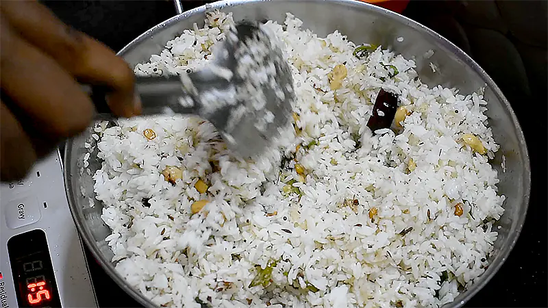 Traditional Coconut Rice Recipe (Thengai Sadam / Kobbari Annam) Steaming coconut rice served on a plate and garnished with fresh coriander leaves