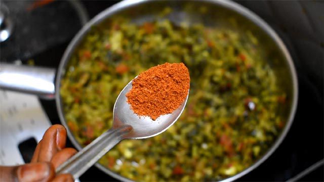 Sprinkle red chilli powder to make Amaranth Leaf Curry.
