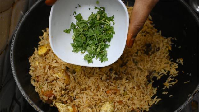 Garnish Chicken Fried Rice with coriander leaves and serve hot.